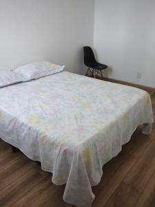 a bedroom with a bed with a blanket on it at Ap aconchegante em Sao Roque in São Roque +2 photos