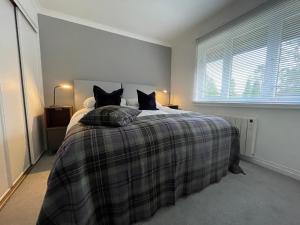 a bedroom with a bed with two black cats on it at Gleneagles Rental in Auchterarder