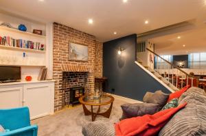a living room with a couch and a fireplace at Seafront Regency Townhouse - Balcony Sea Views in Kent