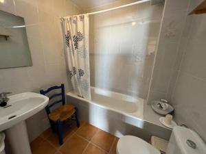 a bathroom with a tub and a toilet and a sink at Casa Coco No 11 in Polopos +82 photos