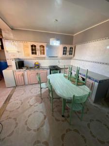 a kitchen with a table and chairs in it at Été in Boumerdes