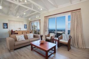 a living room with a couch and a table at Luxury Lodge at Pinnacle Point in Mossel Bay