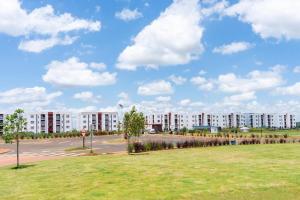 a large apartment building with a park in the foreground at BethelHomes in Tatu City