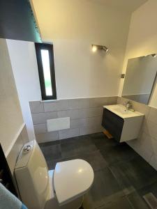 a bathroom with a toilet and a sink and a window at Casa vista dos cerros in Loulé +14 photos