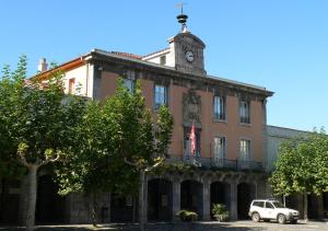 a building with a clock tower on top of it at Apartamento Villabona - Mar y Montaña Elegante Apt p8 con WiFi gratis in Villabona