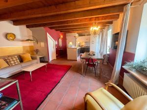 sala de estar con sofá y alfombra roja en Ca' Vendramin - Letters To Juliet, en Verona