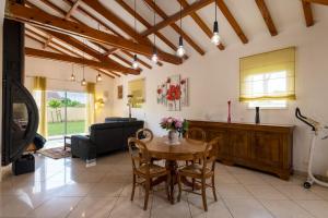 a living room with a table and chairs and a couch at Les Sylphides - Maison avec piscine in Montélimar