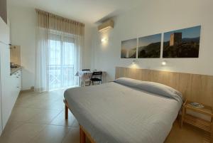 - une chambre avec un lit et une table dans l'établissement Residence Glicini, à Finale Ligure