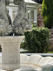 a statue of two lions in a fountain in front of a house at Studio - Sleeps 2 - Pets - Parking - Wifi in York +2 photos