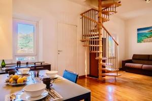 a living room with a spiral staircase in a living room at La Terrazza sul mare in Porto Azzurro