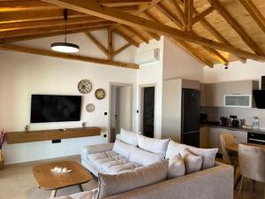 a living room with a couch and a table at Four Seasons Villas in Skiathos Town