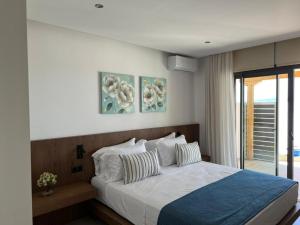 a bedroom with a large bed with two pillows at Four Seasons Villas in Skiathos Town +73 photos