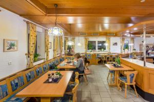 a dining room with wooden tables and chairs at Gasthof Alte Post in Falkendorf