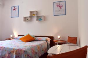 a bedroom with a bed and a table and chairs at B&B Casabianca Palinuro in Palinuro
