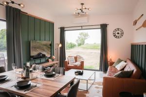 a living room with a table and a large window at Fisherman's Cabin in České Budějovice