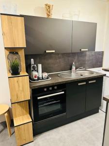 a kitchen with a sink and a counter top at Studio 3 personnes centre ville, avec cour in Calais