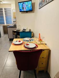 a kitchen with a table with two plates on it at Studio 3 personnes centre ville, avec cour in Calais