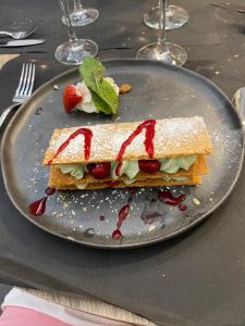 a sandwich on a plate with a strawberry on it at LE CLOS DE LA VINIERE in Jard-sur-Mer