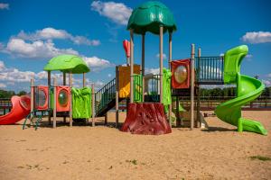 a playground in the sand with colorful slides at Święty Spokój in Żeromin