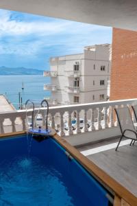a swimming pool on the balcony of a building at Esel Apartments in Sarandë