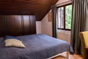a bedroom with a blue bed and a window at Villa Concordia in Budva