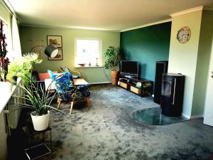 a living room with a couch and a tv at Haus Bärbel in Lietzow