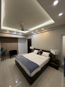 a bedroom with a large bed in a room at High Rise Executive Apartments Facing Centaurus Mall Islamabad in Islamabad