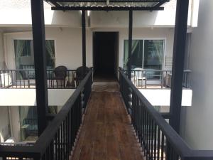 a hallway of a building with a wooden floor at Assasa Huahin in Hua Hin +17 photos