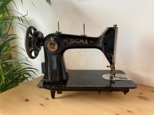a black sewing machine sitting on top of a table at Apartamentos BuenaVista in Colunga