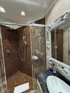 a bathroom with a shower and a sink and a glass shower stall at Delle Nazioni Milan Hotel in Milan