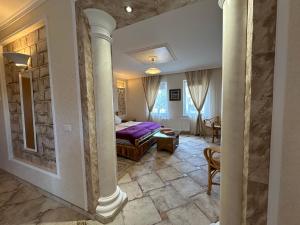 a bedroom with a king sized bed and a living room at Griechischer Palast in Rabenau