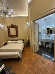 a bedroom with a bed and a bathroom with a tub at Delle Nazioni Milan Hotel in Milan