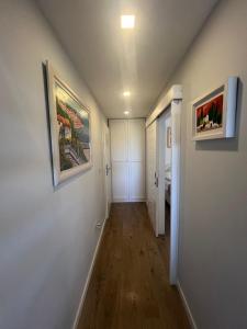 a hallway with two framed paintings on the walls at Luxury apartment in Hotel in Makarska
