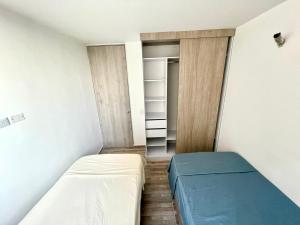 a small room with a bed and a closet at Ciudad Mallorquin in Puerto Colombia
