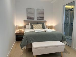 a bedroom with a large bed and two pictures on the wall at Apartamentos Casa Cabot - Rosario in Albacete