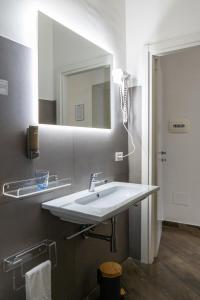 a bathroom with a white sink and a mirror at Hotel San Michele in Naples