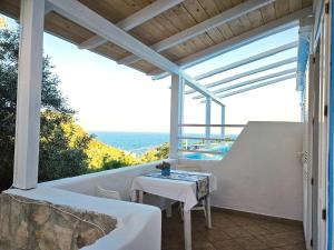 a patio with a table and a view of the ocean at Maridea - Sottovento in Ponza