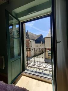 a window with a view of a balcony at Appartement EMILiA Centre ville in Vitré +6 photos