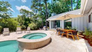 a patio with a pool and a table and chairs at 79 Port Tack in Hilton Head Island
