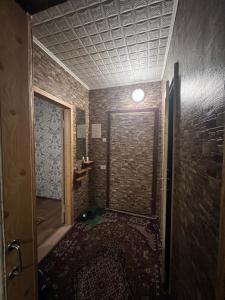 a room with a brick wall and a room with a door at Однокомнатная квартира на Алмазном in Poltava