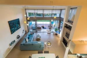 an overhead view of a living room with a blue couch at Island Villa Sani Sea View in Sani Beach