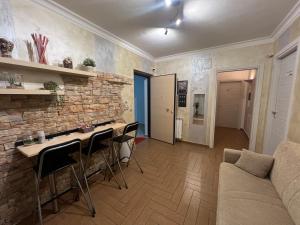 a living room with a couch and a stone wall at B&B Palazzo del Toro in Montesilvano