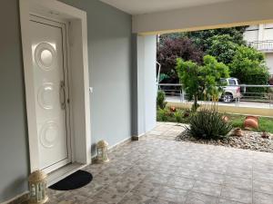 a door to a house with a courtyard at Kamena Home Apartment in Kamena Vourla in Kamena Vourla