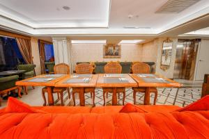 a dining room with orange tables and chairs at OTEL MARCELLO in Istanbul