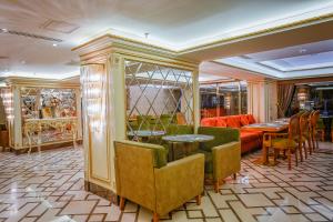 a restaurant with tables and chairs and a couch at OTEL MARCELLO in Istanbul