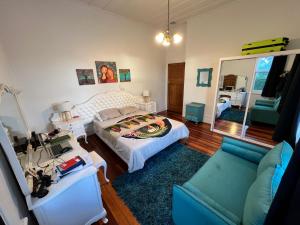 a living room with a bed and a couch at La Casa Bonita Auckland in Auckland