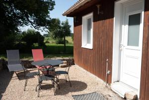 a patio with a table and chairs next to a building at La Tour in Rouffignac +4 photos