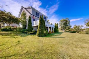 a large house with an american flag on it at Clark Cove in Harpswell Center