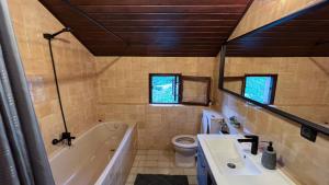 a bathroom with a tub and a toilet and a sink at Villa Concordia in Budva +32 photos