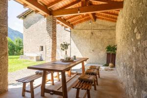 a dining room with a wooden table and chairs at Il Giardino Segreto in Barzio